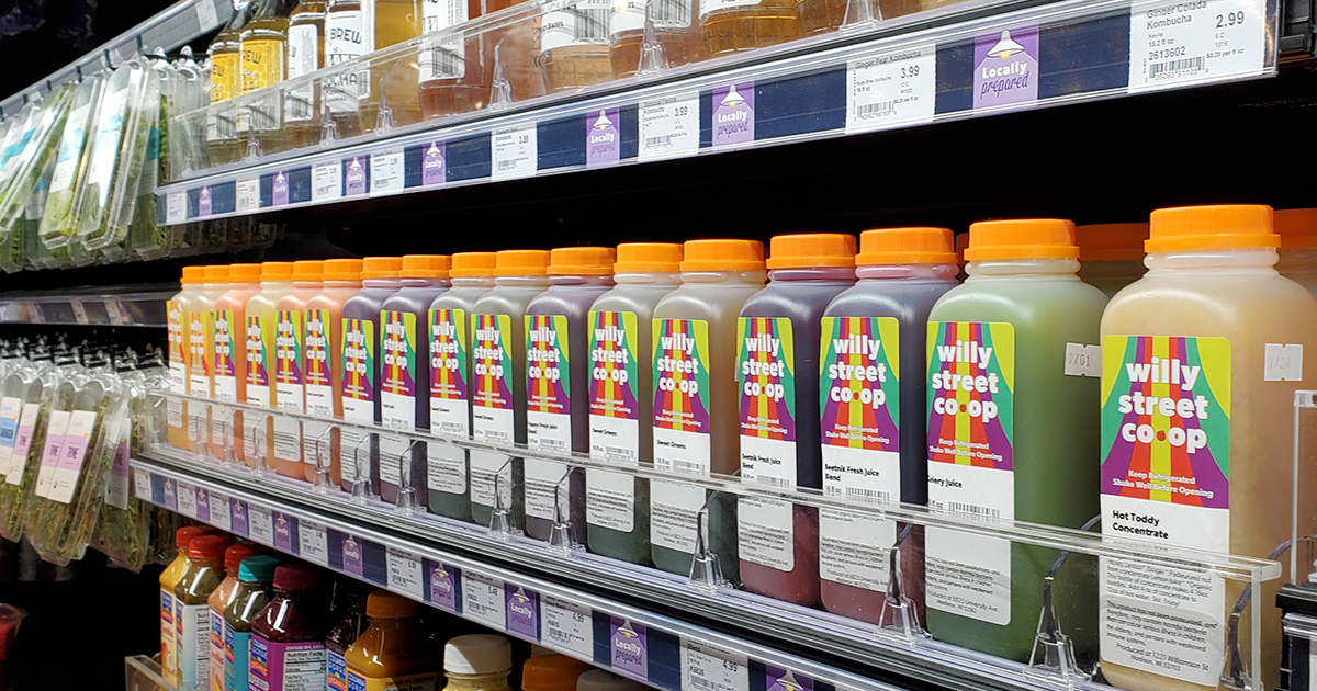 Juice bottles on grocery store cooler shelves