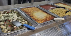 Food in containers at a hot bar