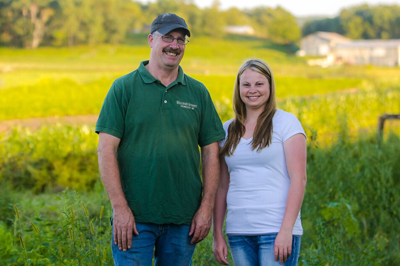 Al and Kayley Weinrich of Wisconsin Growers standing in a field