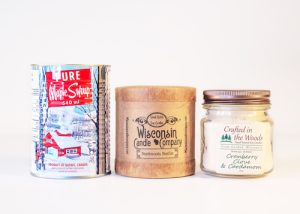 Three candles from three different brands offered at Willy Street Co-op