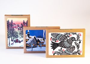 Three boxes of holiday cards, each featuring a different design