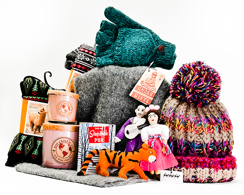 A grouping of knitted hats and mittens, candles, socks, and toys