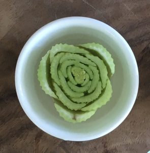 overhead shot of a celery base submerged in water in a bowl