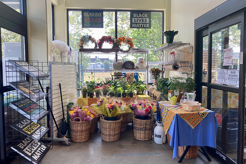 Small floral section at the front window of a grocery store