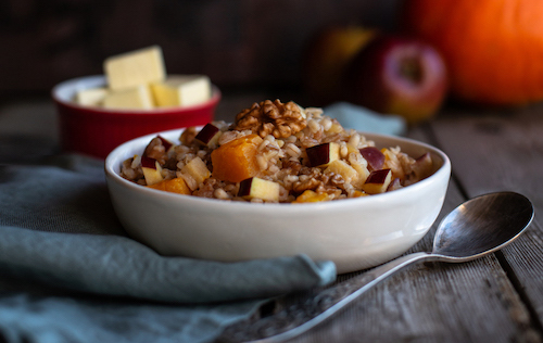 Morning cereal with pumpkin, apples, and nuts. Autumn harvest.