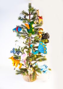 A small holiday pine tree decorated with ornaments from Silk Road Bazaar