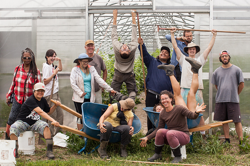 Troy Farm Crew posing goofy in front of a greenhouse