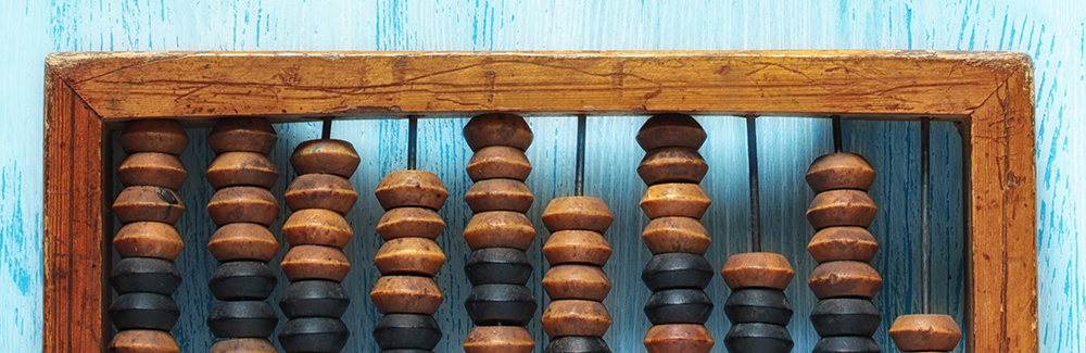 Old wooden scratched vintage decimal abacus on a blue wooden board for the background. Flat lay.