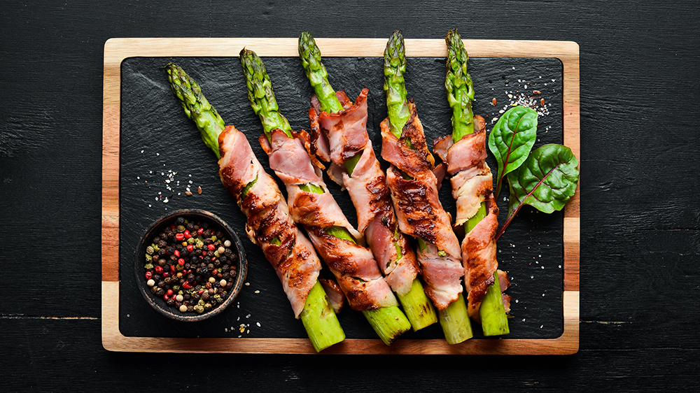 Asparagus baked with bacon and spices. Healthy food. Top view. 