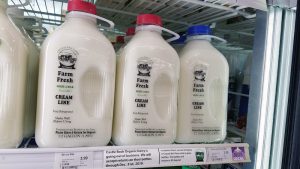 Glass bottles of Crystal Ball Farms milk in the grocery cooler