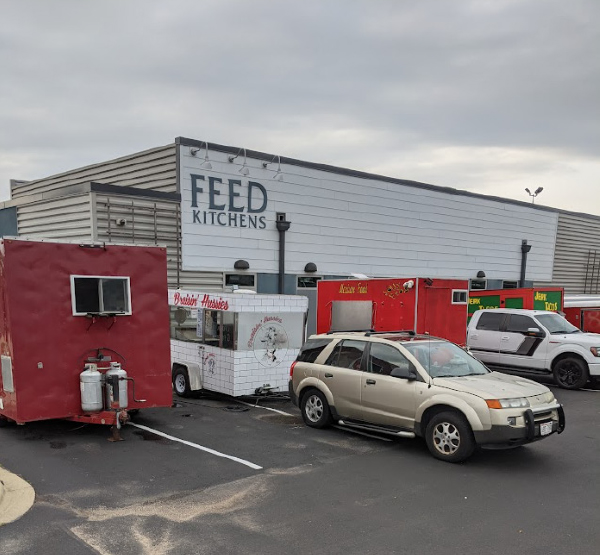 Cars and food trucks outside of Feed Kitchens