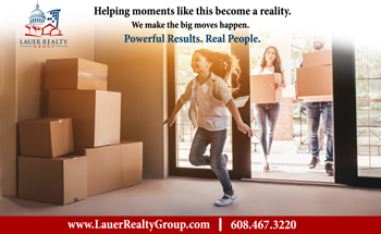 newspaper ad for Lauer Realty Group featuring a young family moving into their new home. Text says "Helping moments like this become a reality. We make the big moves happen. Powerful Results. Real People."