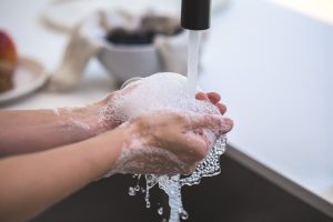 A person washing their hands in a sink