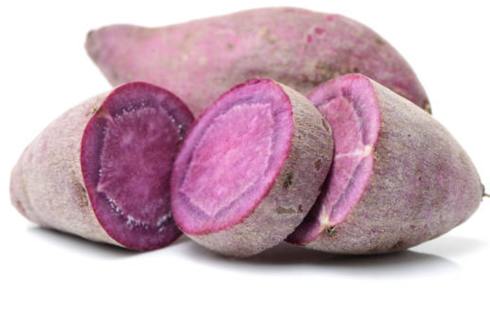 Two purple sweet potatoes, one of them sliced