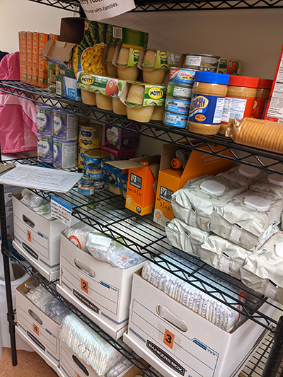 Shelving filled with packages of good and boxes of diapers