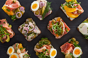 A large amount of open faced sandwiches arranged in a diagonal grid