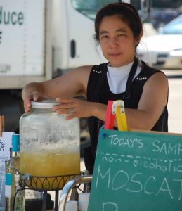 Photo of Mad Maiden owner Janet Chen as she works a farmer's market