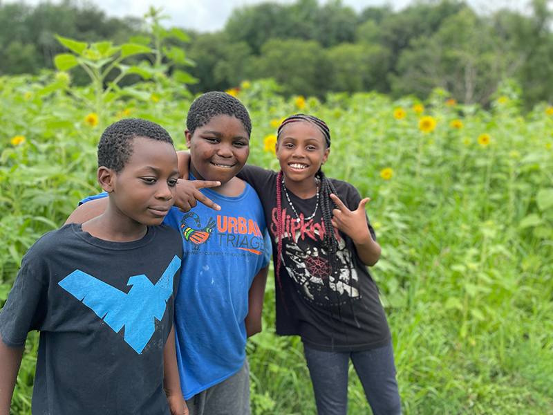 A trio of students pose for a photo